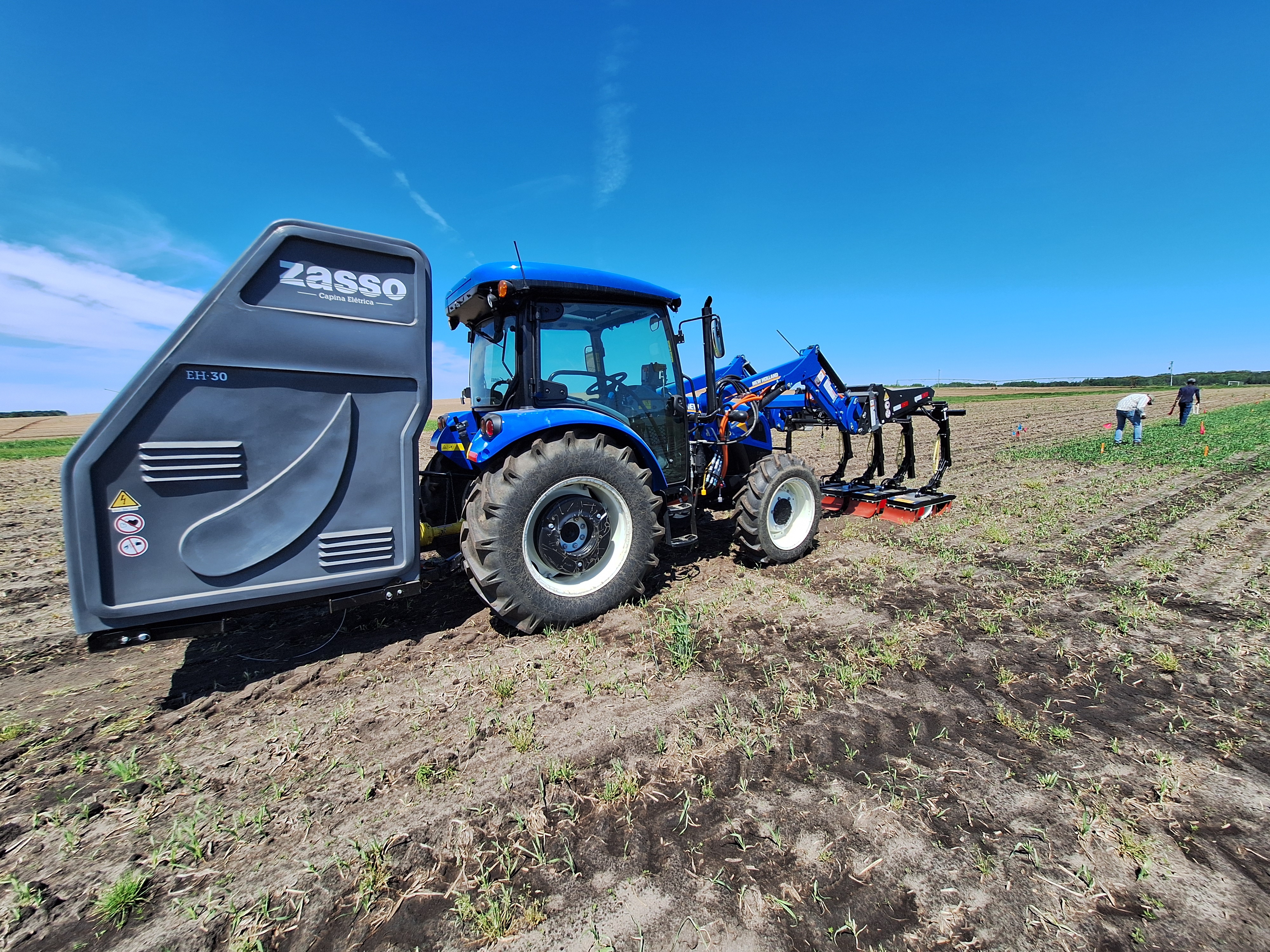 A weed electrocutor tractor sitting in a field.